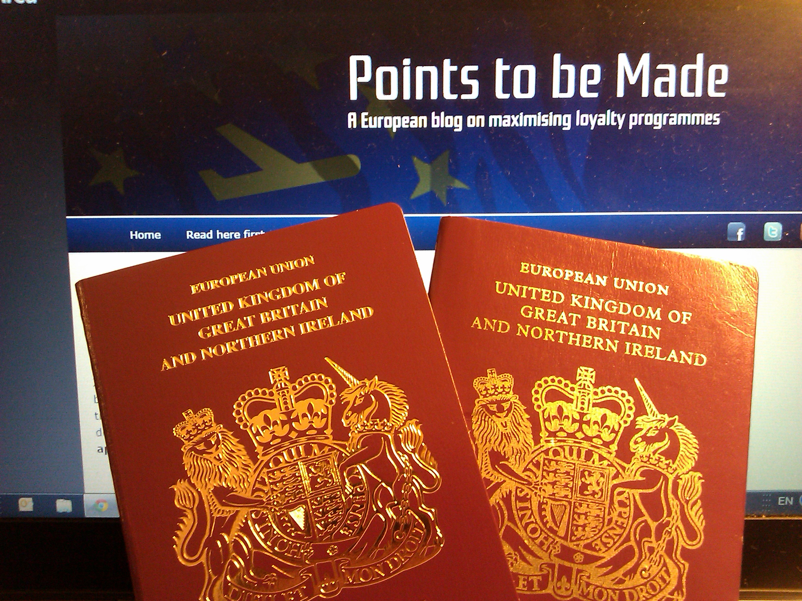 two red passports with gold designs on them