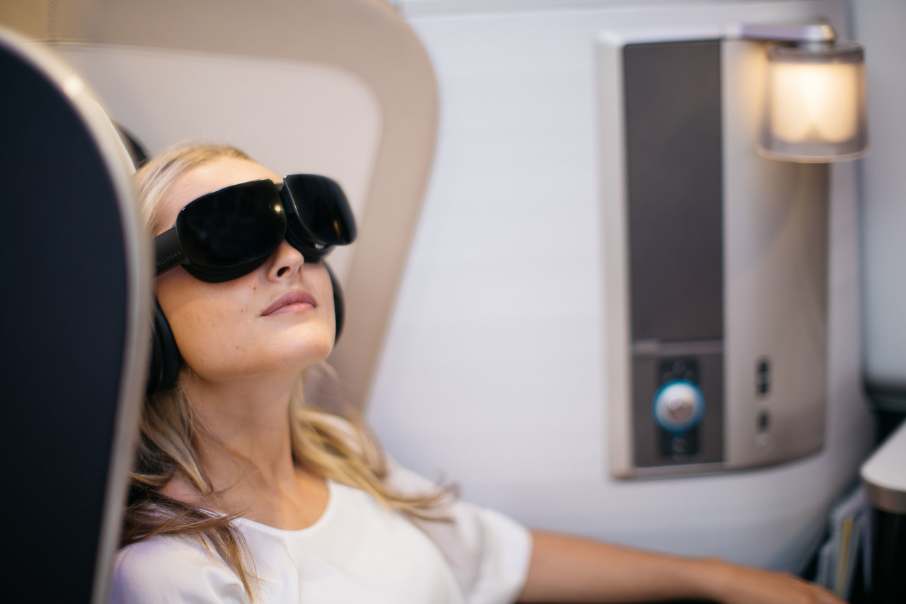 British Airways customer wearing VR headset in First Class