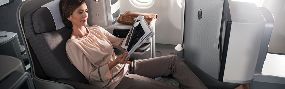 a woman reading a magazine on an airplane