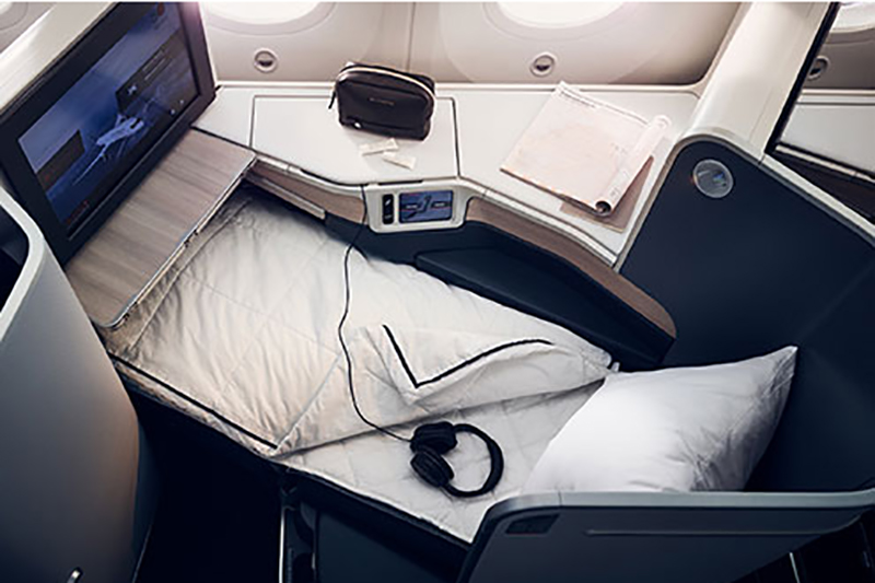 a bed with headphones and a tv on the side of it