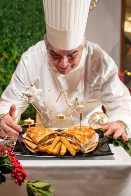 a chef looking at a plate of food