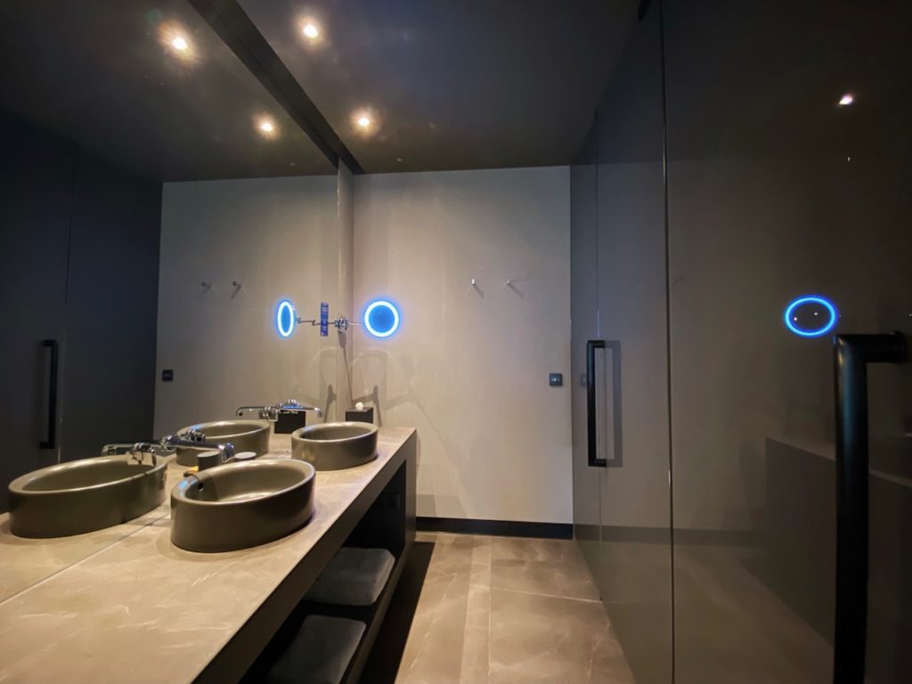 a bathroom with sinks and lights