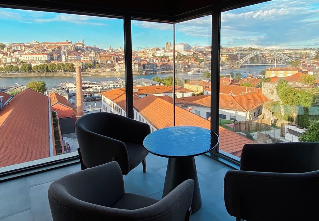 a room with a table and chairs and a view of a city