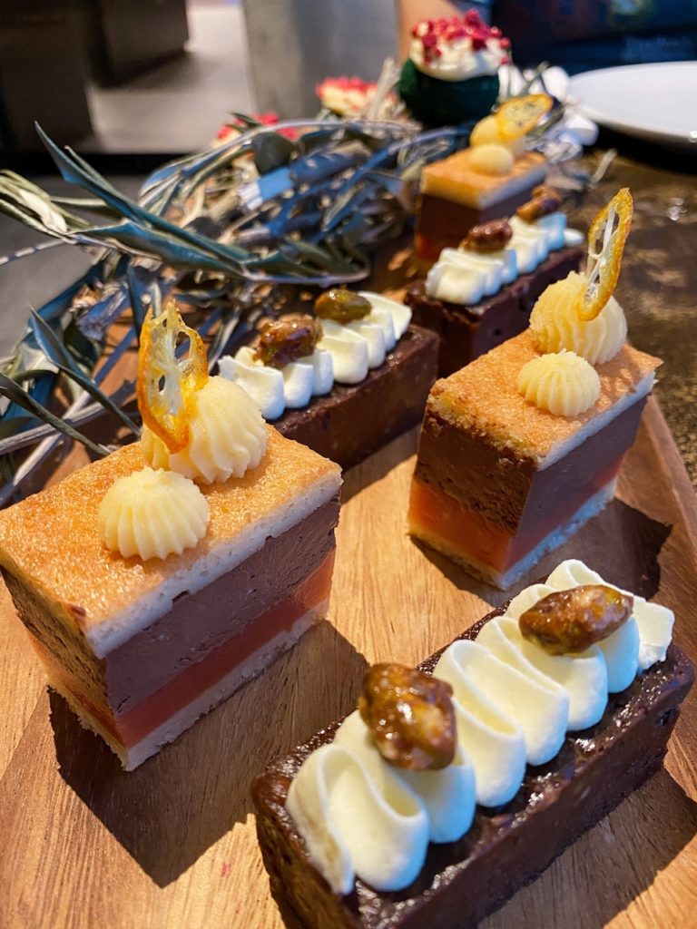 a group of desserts on a wooden tray